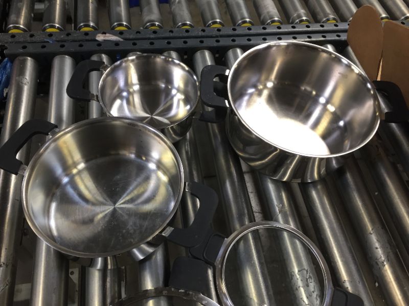 Photo 1 of pack of 3 stainless steel pots and lids in various sizes. 