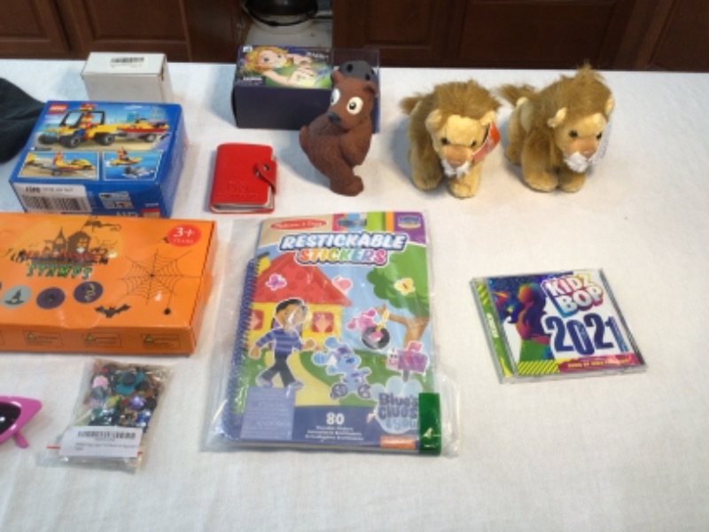 Photo 2 of T Shirts- Black Star Wars and Yellow Plain- size 7, Lego Toy 60286 Beach Rescue ATV, Cat Eye Sunglasses, Zipper Pull Charms, Stickers, Kidz Bop 2021 CD, Game Card Holder, Atlantic Stone Swimming Pool Toy, Wild Republic Stuffed Lions (2)