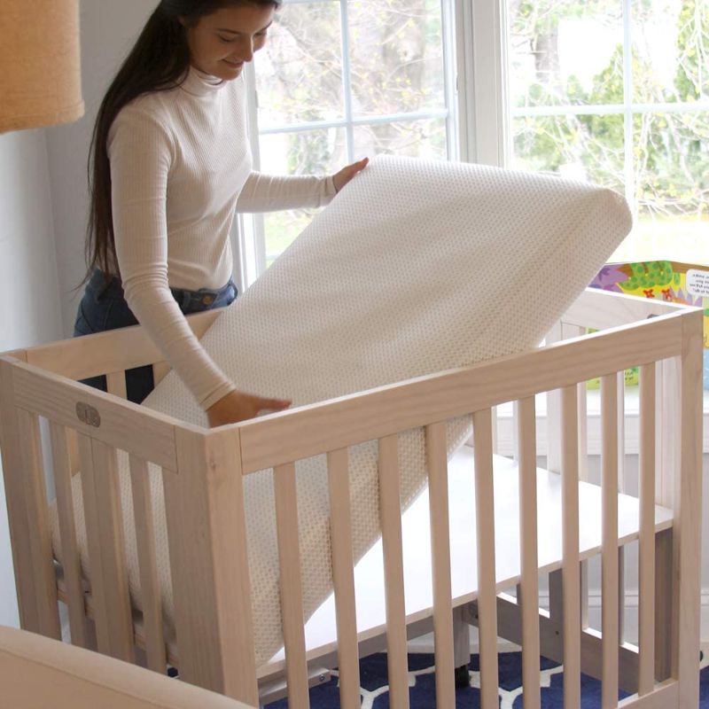 Photo 1 of Lullaby Earth Breathe Safe Mini Crib Mattress - Chemical Free, Dual Firmness Natural Mattress with Removable Washable Protector, 38" x 24"
