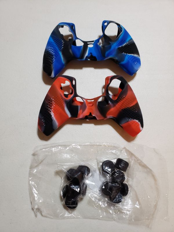 Photo 1 of JOYSTICK AND CONTROLLER SKINS FOR PS5. SET OF 2. RED AND BLUE.