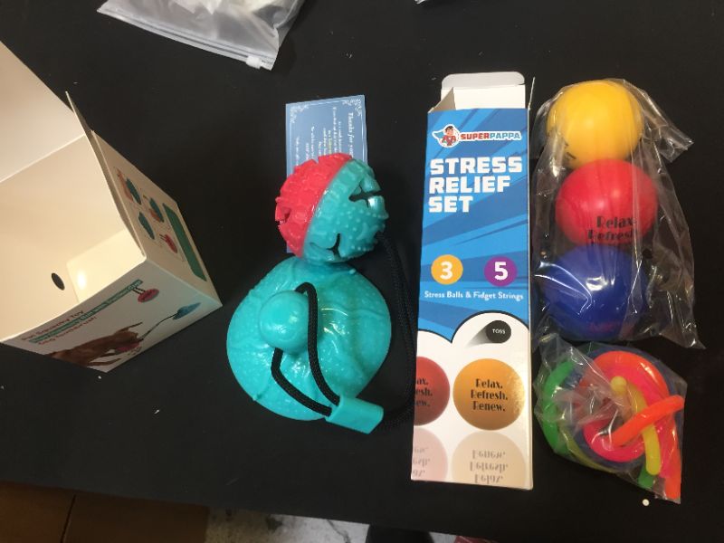 Photo 1 of 2 toy pack, one dog toy and one stress relief pack