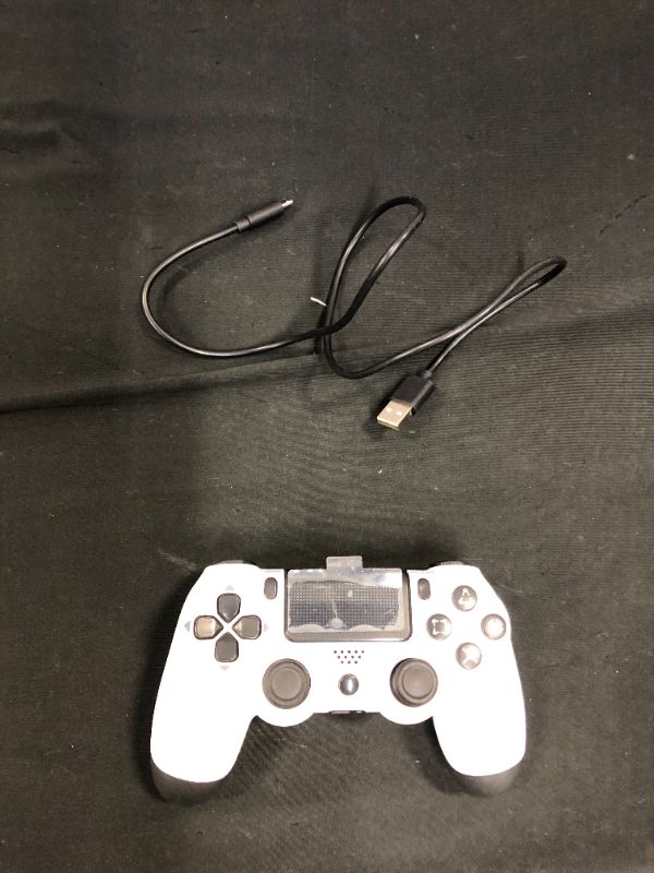 Photo 1 of WHITE AND BLACK PS4 CONTROLLER 