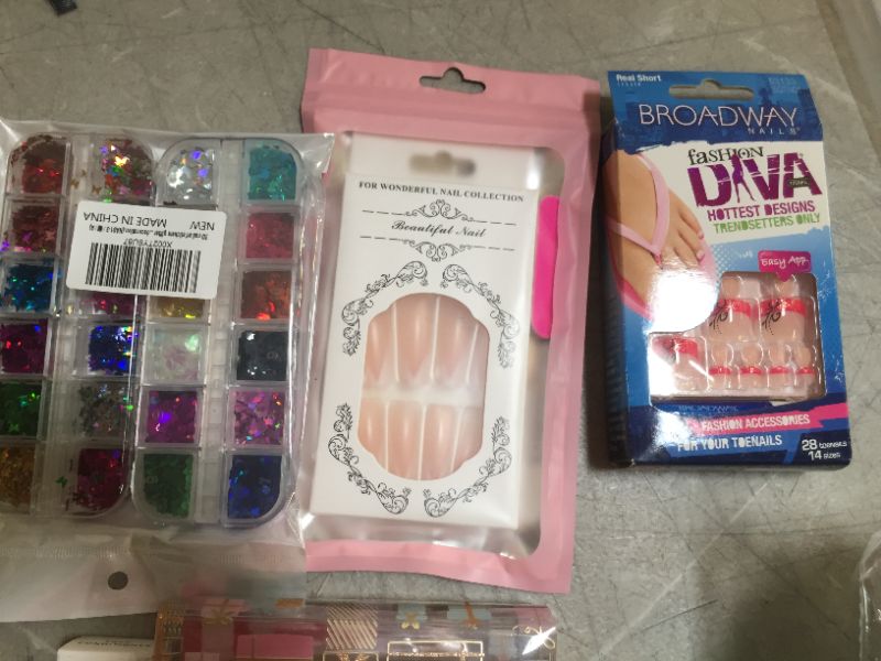 Photo 2 of Assorted Beauty Products (Lipstick, earwax remover, nails, eyelash extender) 