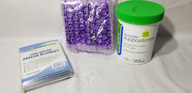 Photo 2 of Primacare CB-6841 Emergency Foil Mylar Thermal Blanket, two pill cutters and a bottle of glycerin suppositories,