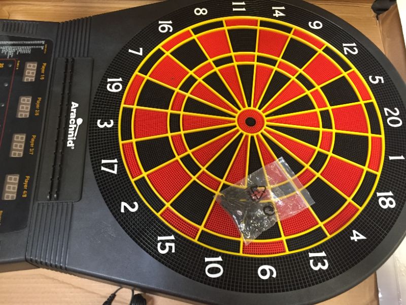 Photo 2 of Arachnid Cricket Pro 650 Electronic Dartboard, missing dart back and has 1 head stuck in a hole