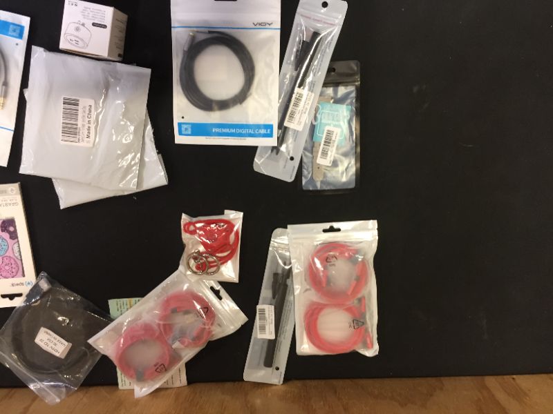 Photo 1 of Assorted technology accessories (smartwatch bands, cables, charging cords) 