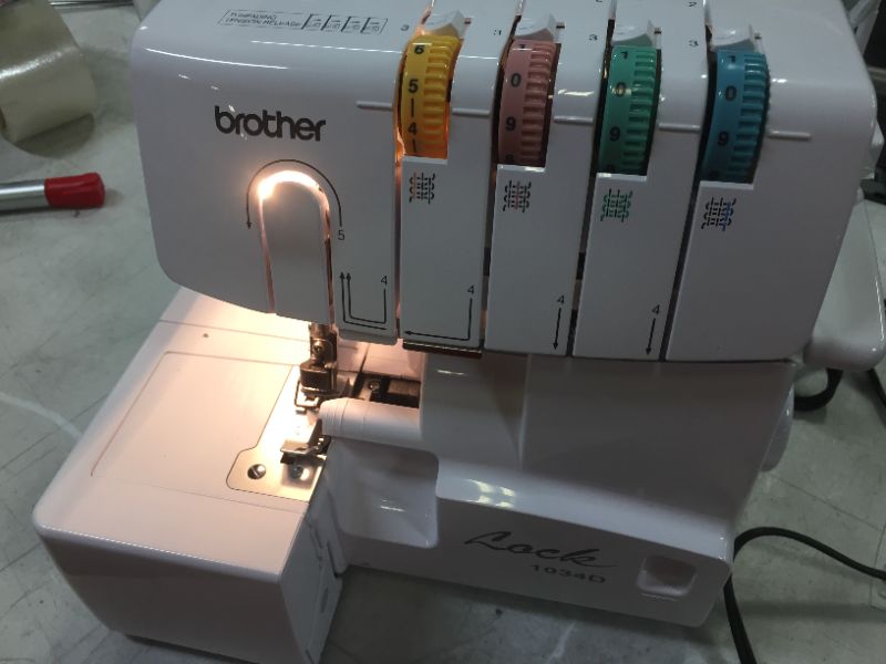 Photo 3 of Brother Serger, 1034D, Heavy-Duty Metal Frame Overlock Machine, 1,300 Stitches Per Minute, Removeable Trim Trap, 3 Included Accessory Feet,White
