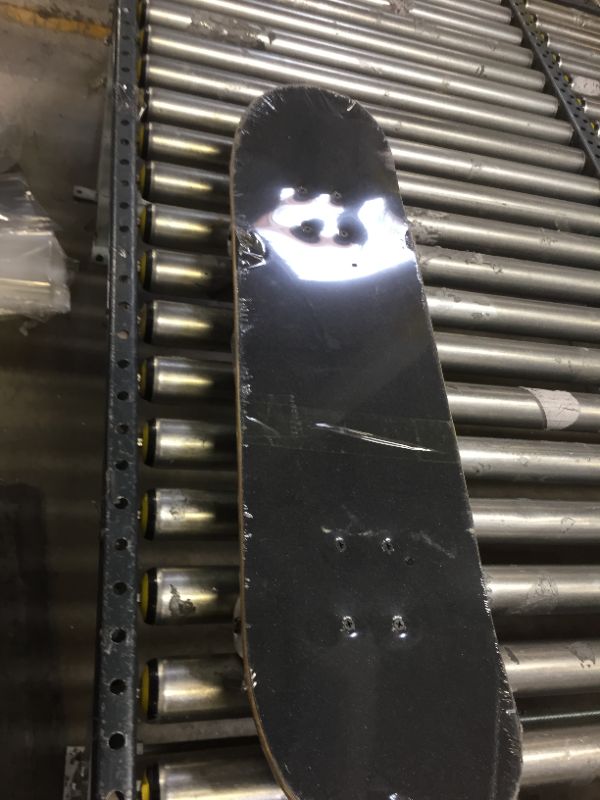 Photo 1 of BLK/WHT CHECKERED 31" SKATEBOARD, TRUCKS LOOSE . WRAPPED IN PLASTIC BUT SLIGHT DINGS/SCRACTHES 