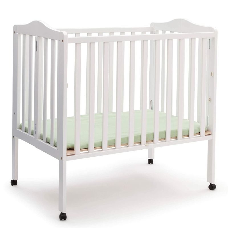 Photo 1 of Delta Children Folding Portable Mini Baby Crib with 1.5-inch Mattress, White
