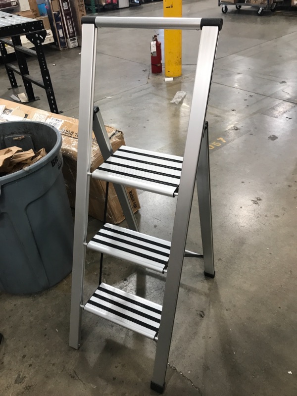 Photo 2 of (WOBBLY) 

(missing bottom rubber foot guard) 
3 step ladder (STOCK PHOTO DOES NOT ACCURATELY REFLECT ACTUAL PRODUCT) 