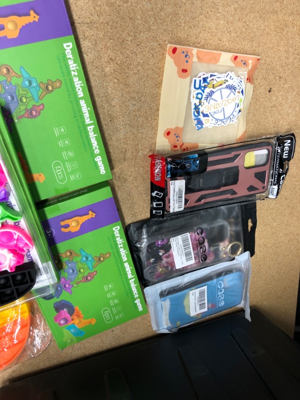 Photo 2 of BUNDLE OF FIDGET TOYS, PHONE CASES, UKRAINE STICKERS AND HALLOWEEN WINDOW DECO.