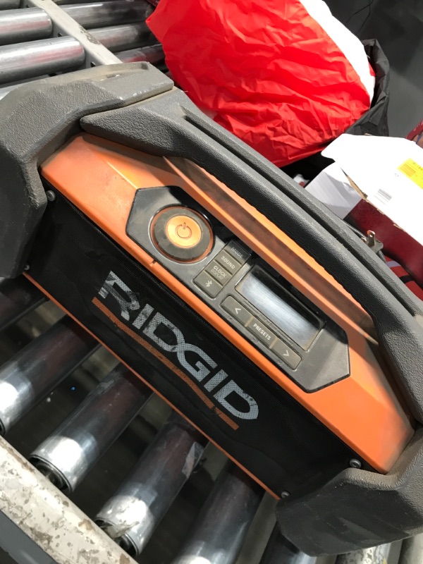 Photo 2 of **USED**
Ridgid R84087 18V Lithium Ion Cordless / Corded Jobsite Radio with Bluetooth, Aux, and AM/FM capabilities (AAA Battery and Aux Cord Included, 18V Battery Not Included)