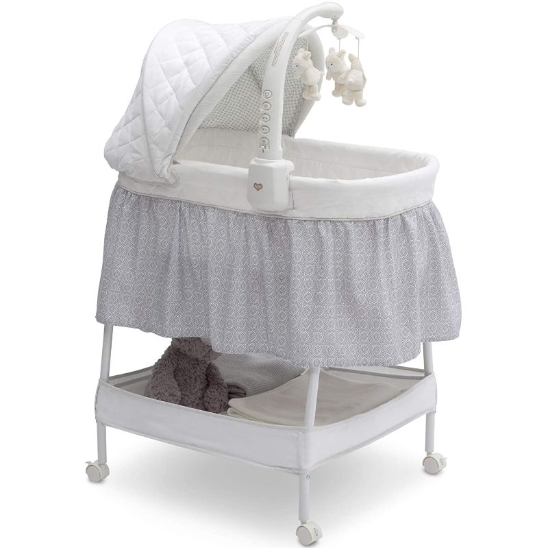 Photo 1 of 
Delta Children Smooth Glide Bedside Bassinet - Portable Crib with Activity Mobile Arm Featuring Spinning Toys, Nightlight and Music, Silver Linings
Style:Bassinet