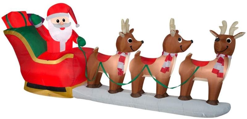 Photo 1 of *both NONFUNCTIONAL* 
Home Accents Holiday 12 ft Giant Inflatable Santa with Sleigh Scene and LED Lights and 6 ft Pre-Lit LED Airblown Dachshund Dog with Rainbow Sweater Christmas Inflatable
