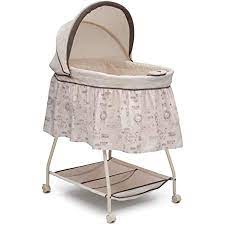 Photo 1 of Delta Children Deluxe Sweet Beginnings Bedside Bassinet - Portable Crib with Lights and Sounds, Falling Leaves
