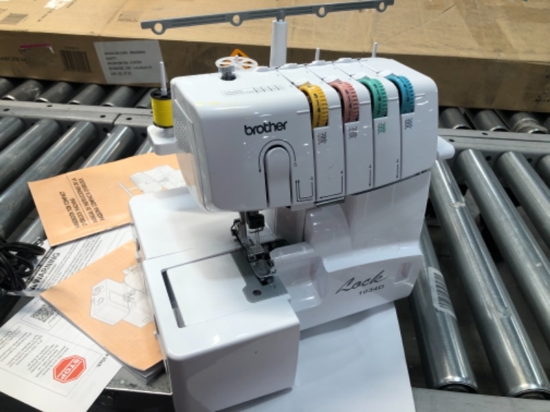 Photo 2 of Brother Serger, 1034D, Heavy-Duty Metal Frame Overlock Machine, 1,300 Stitches Per Minute, Removeable Trim Trap, 3 Included Accessory Feet,White
//TESTED POWER ON 