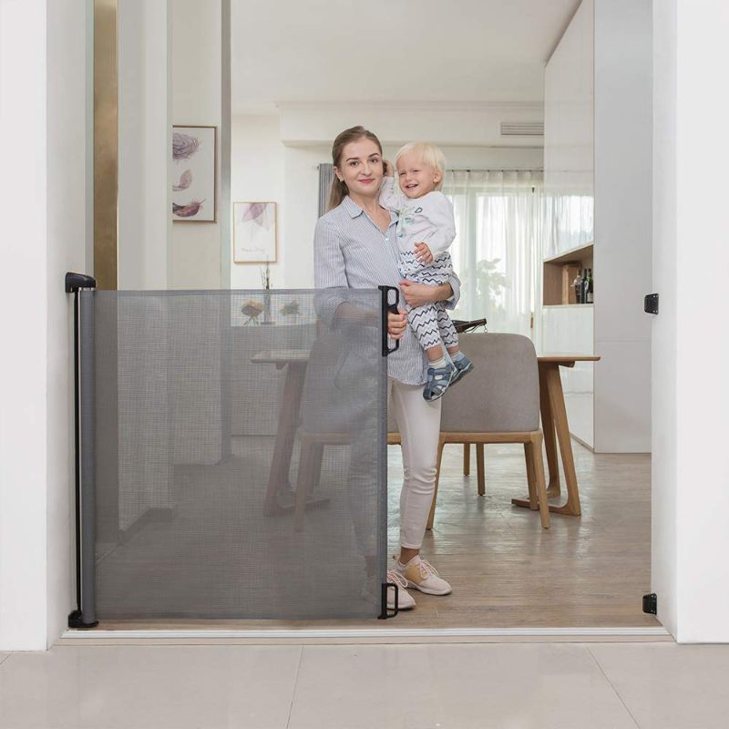 Photo 1 of EasyBaby Products Extra Wide and Extra Tall Indoor Outdoor Retractable Baby Gate Extends up to 71" Wide, 39.3" (100cm) Tall, Grey
