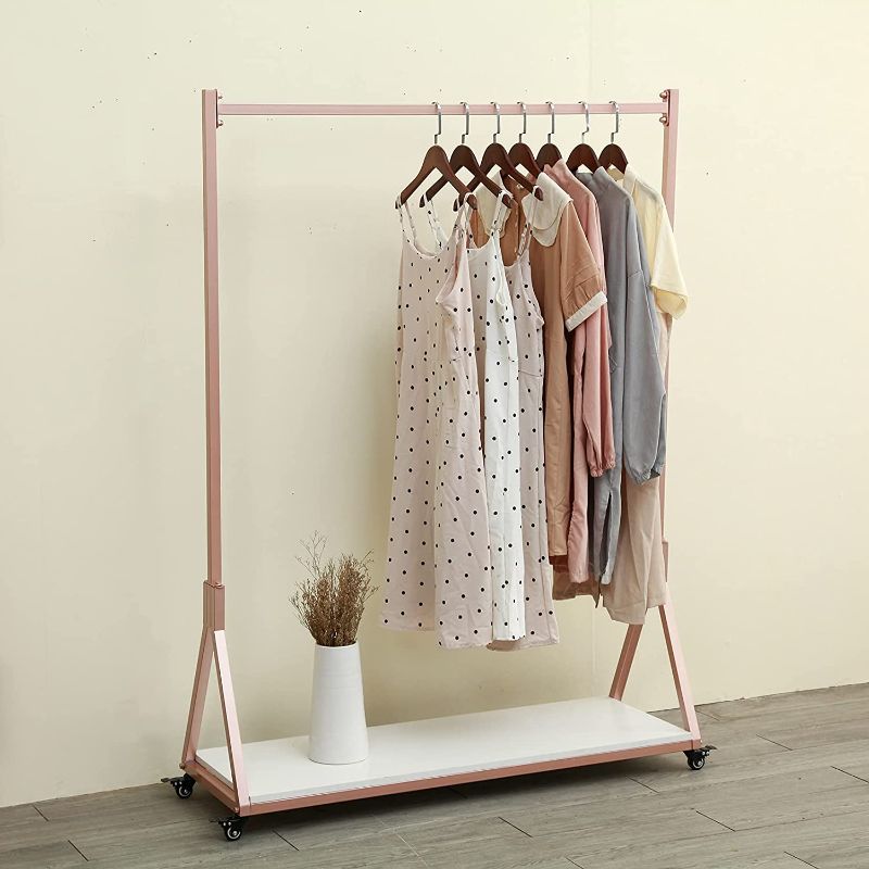 Photo 1 of FURVOKIA Modern Simple Heavy Duty Metal Rolling Garment Rack with Wheel,Retail Display Clothing Rack with Wood,Iron Single Rod Floor-Standing Hangers Clothes Shelves (Rose Gold Square Tube B, 39 L)
//piece is breaking down //missing instructions 