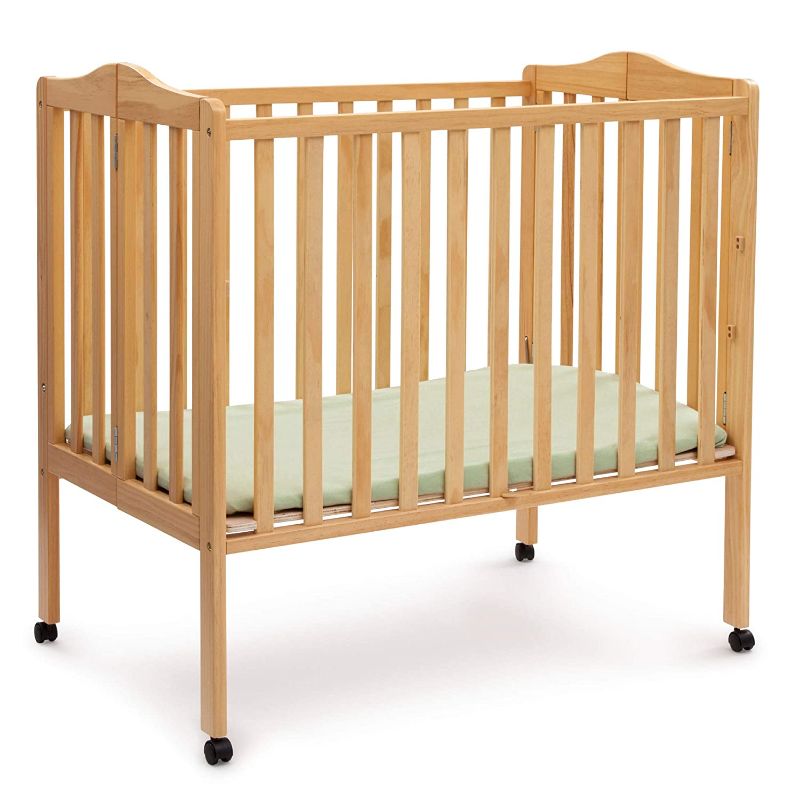 Photo 1 of Delta Children Folding Portable Mini Baby Crib with 1.5-inch Mattress, Natural
