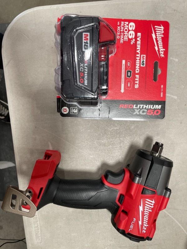 Photo 3 of 1/2" Drive 18 Volt Pistol Grip Cordless Impact Wrench & Ratchet with MILWAUKEE'S 48-11-1850 M18 Redlithium 5.0Ah Bat Pack
