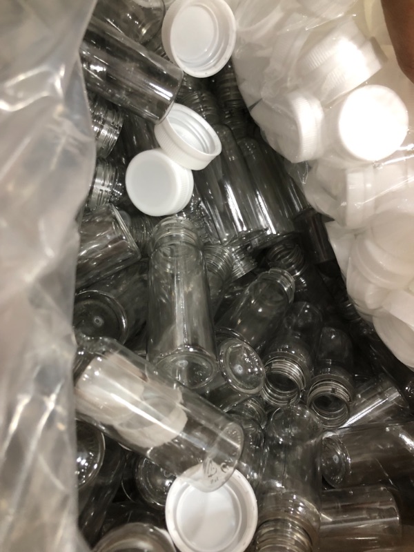 Photo 2 of [1100 Pk] 2 oz Small Plastic Juice Bottles, Bulk 1100 Mini Clear Round Bottles and White Lids Caps for Liquids Smoothies | Juicing Business Bulk Pack
- Lids don't fit bottle (Lids to big) // Loose components 
