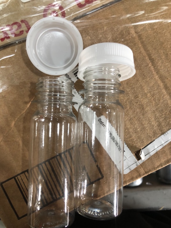 Photo 3 of [1100 Pk] 2 oz Small Plastic Juice Bottles, Bulk 1100 Mini Clear Round Bottles and White Lids Caps for Liquids Smoothies | Juicing Business Bulk Pack
- Lids don't fit bottle (Lids to big) // Loose components 
