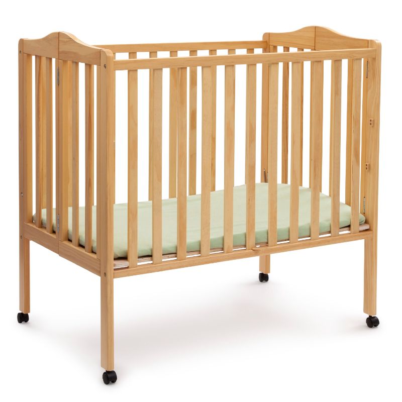 Photo 1 of Delta Children Folding Portable Mini Crib with 1.5-inch Mattress, Natural
