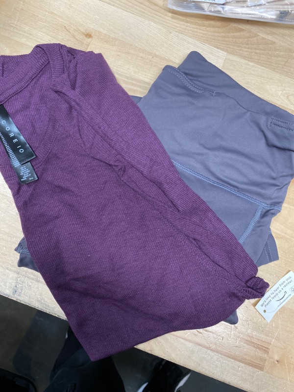 Photo 1 of WOMENS CLOTHES IN SIZE M 
GRAY LEGGINGS AND PURPLE TANK 