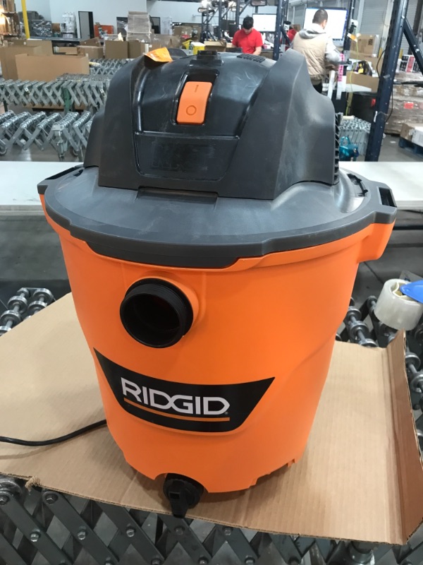 Photo 2 of RIDGID 12 Gal. 5.0-Peak HP NXT Wet/Dry Shop Vacuum with Filter, Hose and Accessories, Oranges/Peaches
**USED, FUNCTIONS**