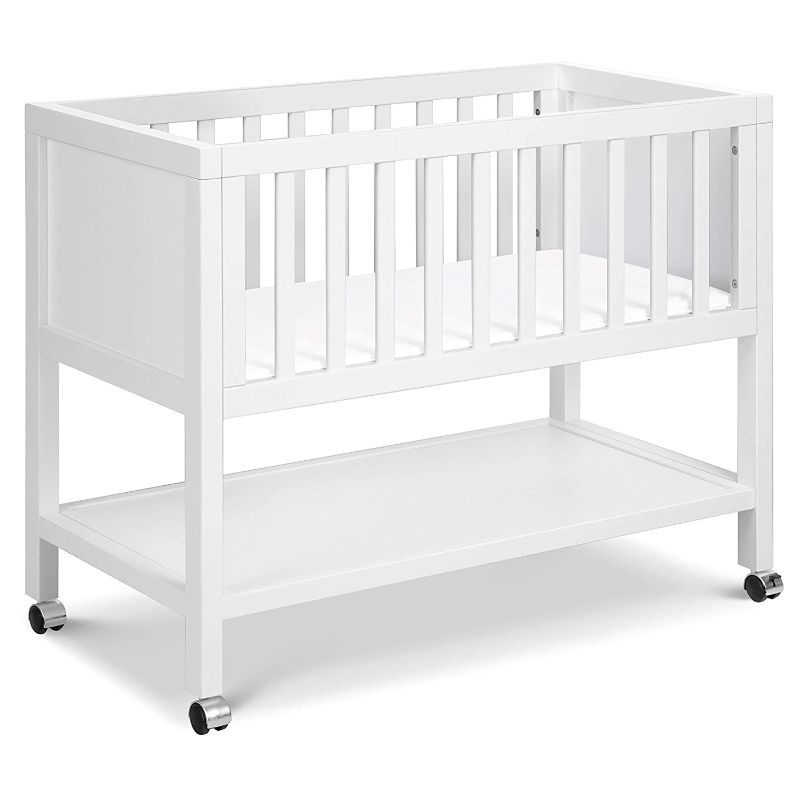 Photo 1 of **cut on side of mattress**
DaVinci Archie Portable Bassinet in White, Removeable Wheels, Greenguard Gold Certified
