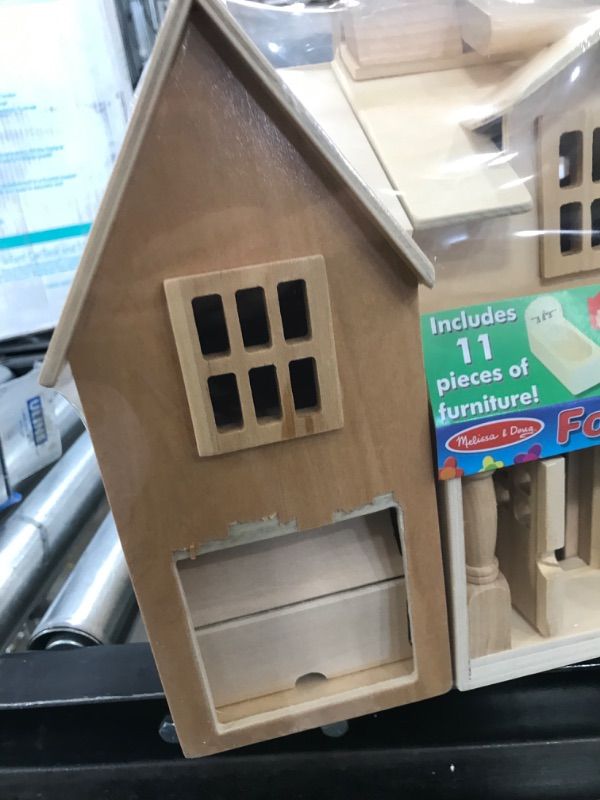 Photo 1 of Melissa & Doug Fold & Go Wooden Dollhouse with 2 Play Figures and 11 Pieces of Furniture
