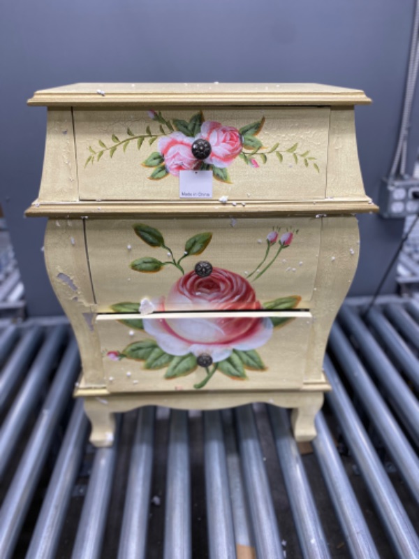 Photo 2 of **LIGHT PAINT CHIPS IN  WOOD AND IN SEAMS OF DRESSER** 3 Drawer Antique Night Stand with Floral Art
Details:
Brown
12" x 20.5" x 26.5"
3 drawers
Floral art
For indoor use