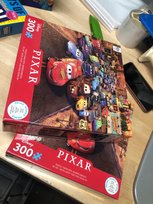 Photo 2 of **SET OF 2**
Ceaco Disney Pixar Cars Jigsaw Puzzle - 300pc
