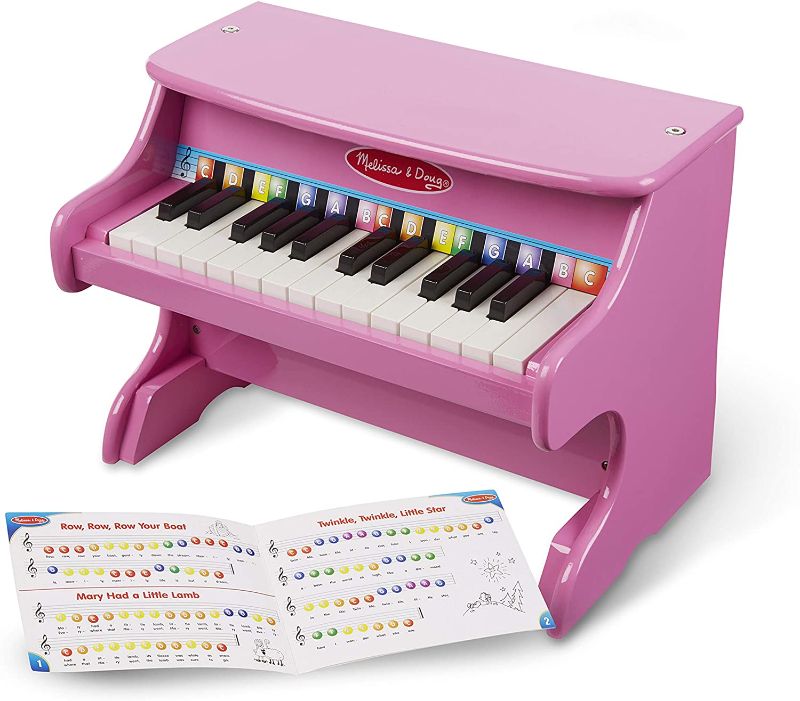 Photo 1 of *USED*
*MISSING songbook*
*SEE last picture for damage*
Melissa & Doug Learn-to-Play Pink Piano With 25 Keys and Color-Coded Songbook
