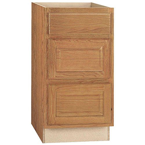 Photo 1 of **DAMAGE TO SIDE PANEL OF CABINET**
Hampton Bay Hampton Medium Oak Raised Panel Assembled Drawer Base Kitchen Cabinet with Drawer Glides (18 in. X 34.5 in. X 24 in.)
