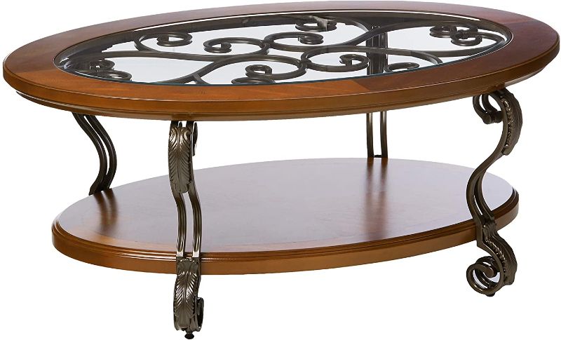 Photo 1 of Signature Design by Ashley - Nestor Traditional Glass Top Oval Coffee Table w/ Fixed Shelf, Medium Brown
