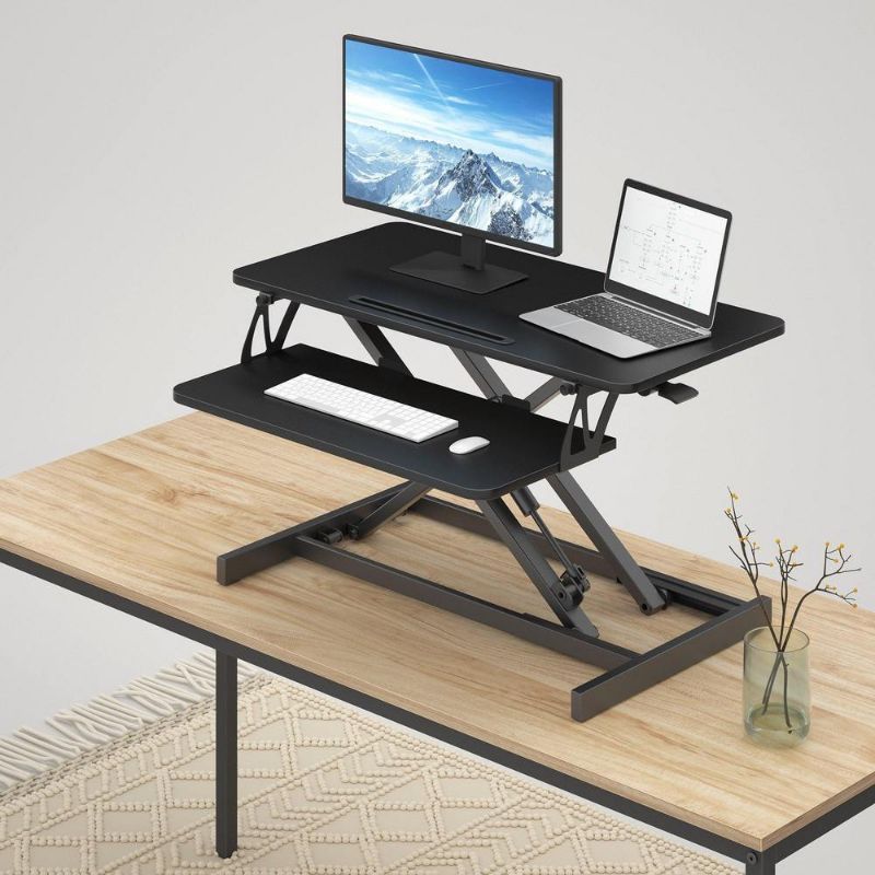 Photo 1 of FEZIBO Standing Desk Converter, Stand up Desk Riser, Sit Stand Desk Adjustable Height Lift Desks Computer Workstation for Home Office 30 Inch Black
