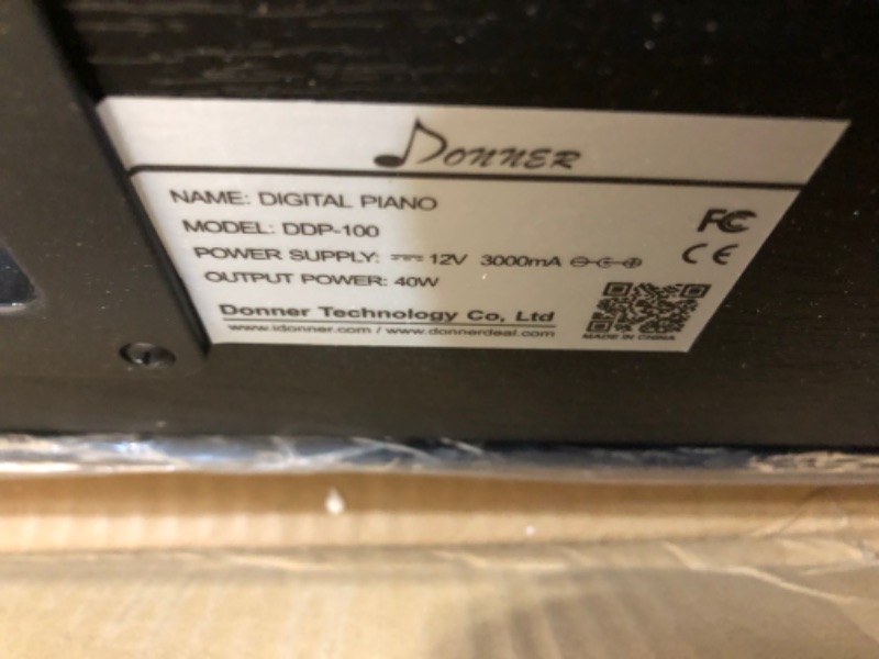 Photo 1 of Donner DDP-100 88-Key Weighted Action Digital Piano, Beginner Bundle with Furniture Stand, Power Adapter, Triple Pedals, MP3 Function, Black ***MISSING LEG***
