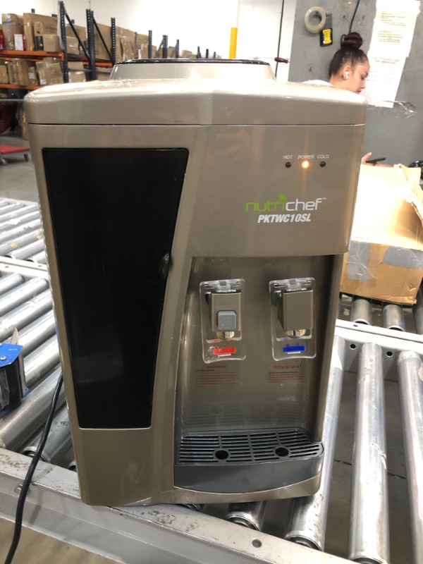 Photo 1 of NO JUG INCLUDED 
Nutrichef Countertop Water Cooler Dispenser - Hot & Cold Water, with Child Safety Lock, Black-Chrome
tested and working 