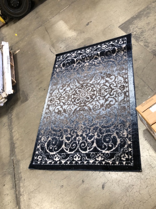 Photo 1 of 3'5" X 5' BLUE RUG
AS IS USED, DAMAGED, PLEASE SEE PHOTOS 
