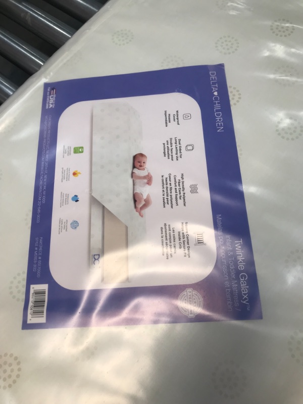 Photo 2 of Delta Children Twinkle Galaxy Dual Sided Crib and Toddler Mattress - Premium Sustainably Sourced Fiber Core - Waterproof - GREENGUARD Gold Certified (Non-Toxic) - 7 Year Warranty - Made in USA
