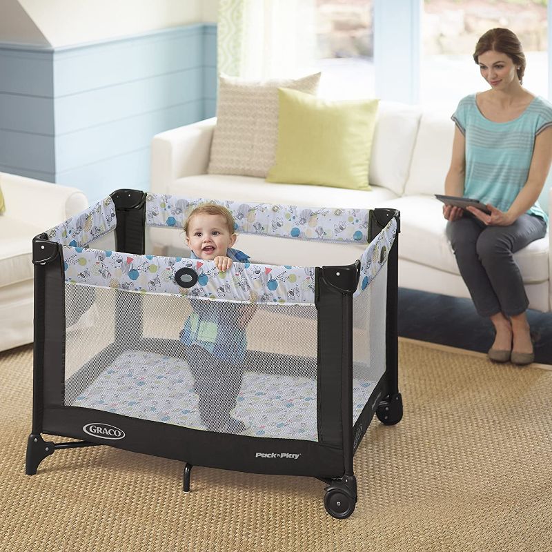 Photo 1 of **USED**ACTUAL DESIGN IS DIFFERENT FROM STOCK PHOTO**
Graco Pack and Play Portable Playard, Push Button Compact Fold, Carnival
