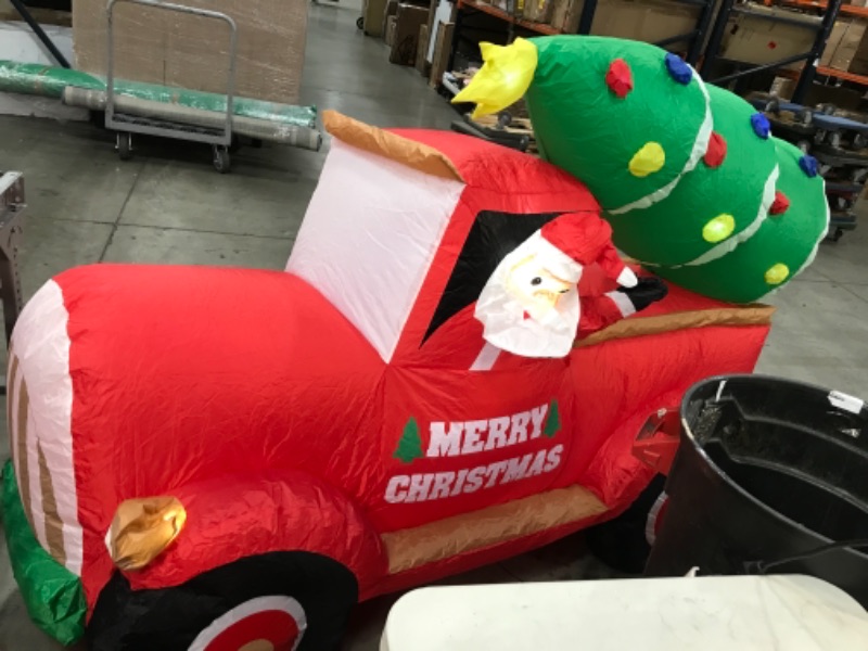 Photo 4 of (INFLATS DESPITE PUNCTURED SIDE)
inflatable merry christmas santa in a truck with a tree