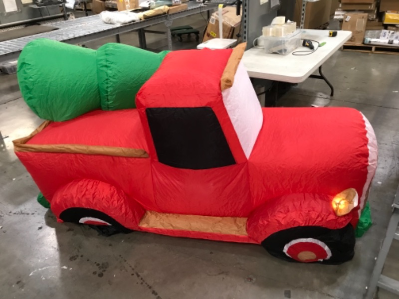 Photo 3 of (INFLATS DESPITE PUNCTURED SIDE)
inflatable merry christmas santa in a truck with a tree