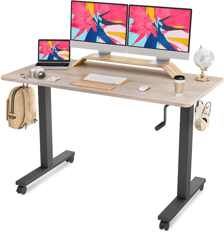 Photo 1 of FAMISKY Crank Adjustable Height Standing Desk, 55 x 24 Inches Manual Stand up Desk, Sit Stand Workstation for Home Office with Handle and Splice Board, Black Frame/Greige Top
