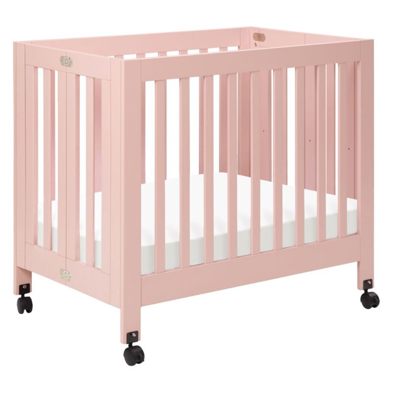 Photo 1 of *factory packaged/ strapped/ sealed* 
Babyletto Origami Mini Portable Crib with Wheels in Petal Pink, 2 Adjustable Mattress Positions, Greenguard Gold Certified, 39.2 x 25.7 x 36 inches	