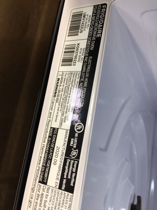 Photo 3 of Frigidaire 1.4 Cu. Ft. Compact Over-the-Range Microwave in Stainless Steel with Automatic Sensor Cooking back end is damaged
