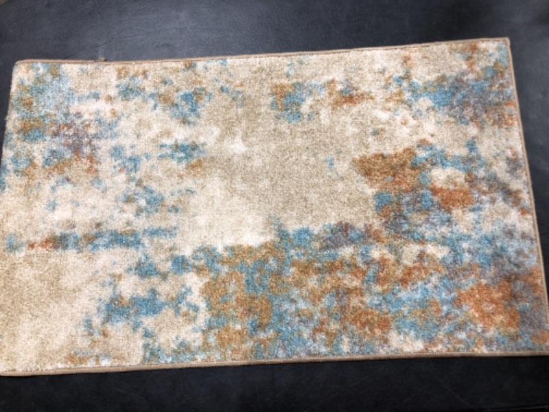 Photo 1 of 20in x 34in rug, speckled design with  different shades of orange, brown, blue, gray