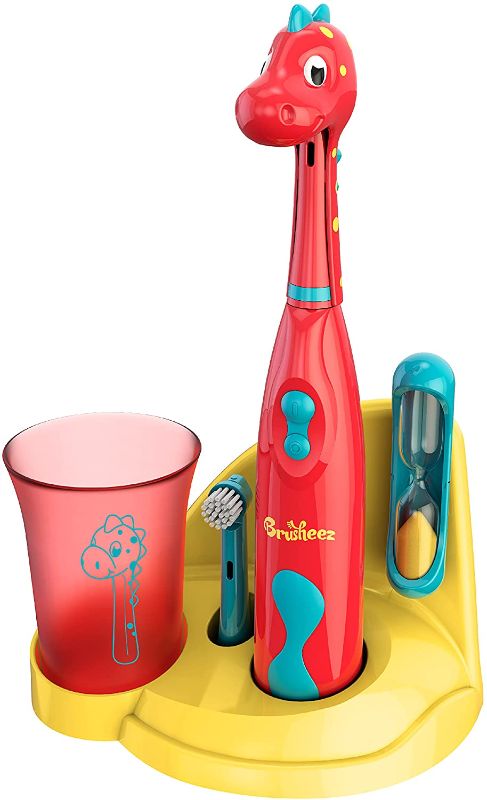 Photo 1 of Brusheez® Kids Electric Toothbrush Set (Carnivore Edition) - Battery Operated, Soft Bristles, Easy On/Off, 2 Brush Heads, Animal Cover, Sand Timer, Rinse Cup, and Base - Ages 3+ (Pepper The Dino)
