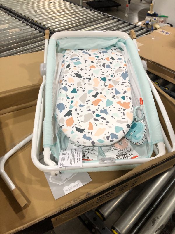 Photo 2 of Fisher-Price Rock with Me Bassinet Pacific Pebble, Portable Bassinet with Rocking Motion and Soothing Features for Newborns and Infants
